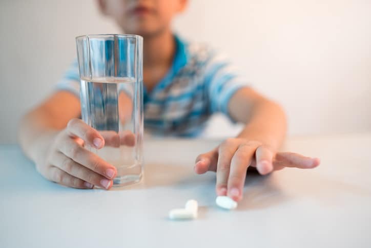 child taking medication